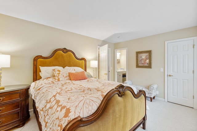 carpeted bedroom with ensuite bath