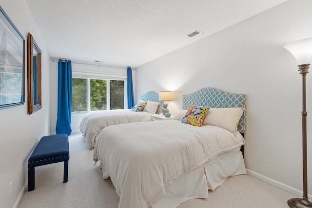 carpeted bedroom featuring a textured ceiling