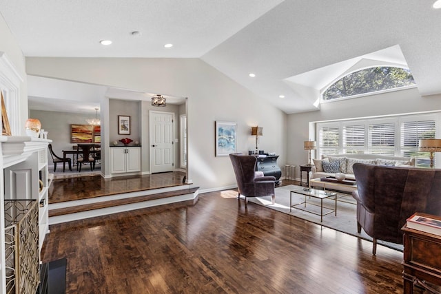 interior space featuring an inviting chandelier, hardwood / wood-style floors, a textured ceiling, and high vaulted ceiling