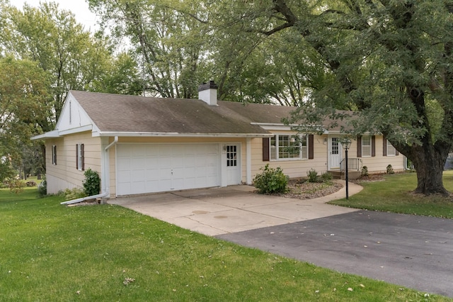 ranch-style house featuring a garage and a front yard