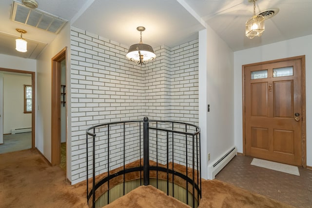 carpeted foyer entrance with a notable chandelier and a baseboard radiator