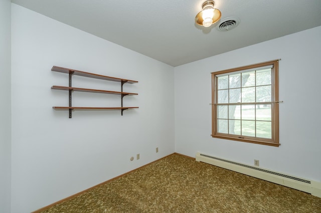 spare room featuring carpet floors and a baseboard radiator