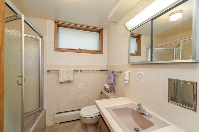 full bathroom with vanity, tile walls, toilet, and a baseboard heating unit