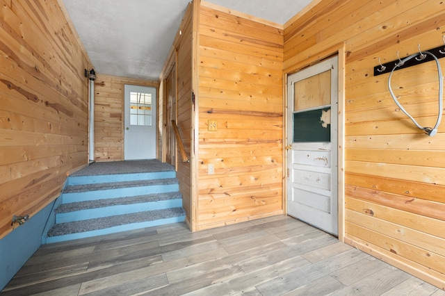 2135 24th Ave SW, Pine River Twp, MN 56474 - staircase with wooden walls and wood finished floors