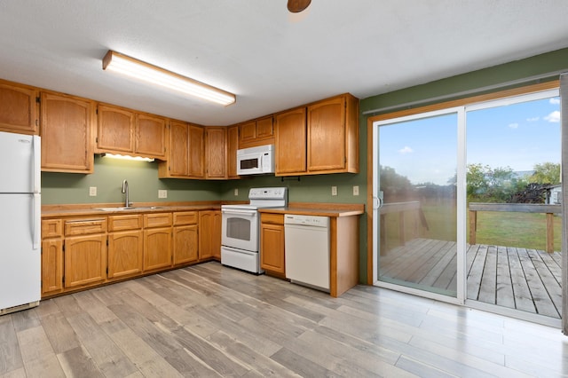 2135 24th Ave SW, Pine River Twp, MN 56474 - kitchen with white appliances, a sink, light wood-style floors, and light countertops