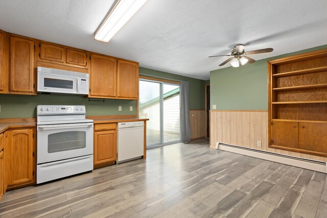 2135 24th Ave SW, Pine River Twp, MN 56474 - kitchen with white appliances, a textured ceiling, ceiling fan, wainscoting, and light wood-style flooring