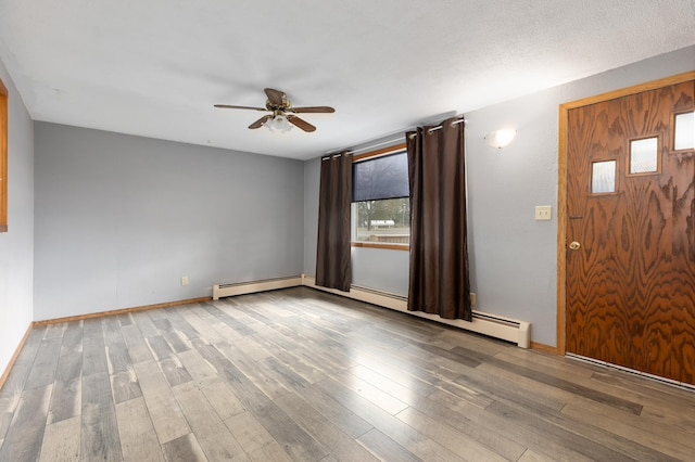 2135 24th Ave SW, Pine River Twp, MN 56474 - foyer entrance featuring ceiling fan, wood finished floors, baseboards, and a baseboard heating unit