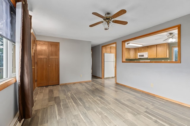 2135 24th Ave SW, Pine River Twp, MN 56474 - unfurnished living room featuring a ceiling fan, light wood-style floors, and baseboards