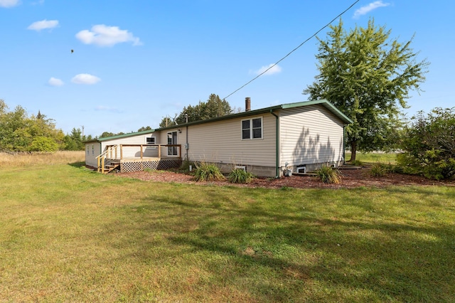 2135 24th Ave SW, Pine River Twp, MN 56474 - rear view of house with a wooden deck and a lawn