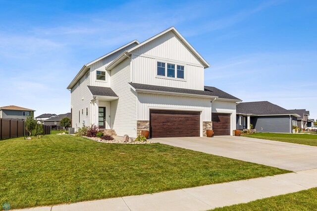 view of front of house with a front yard and a garage