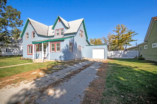 view of front of home with a garage and a front lawn