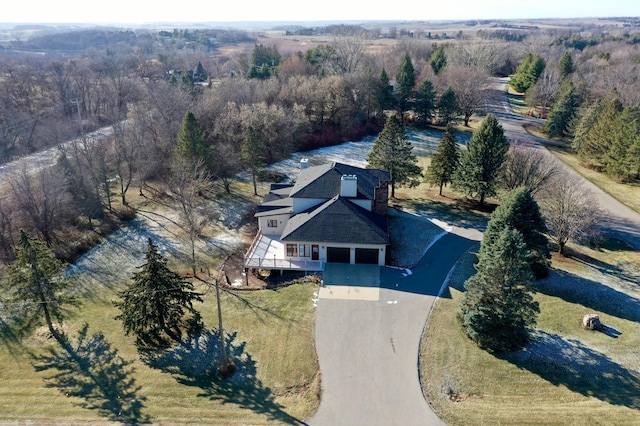 birds eye view of property with a forest view