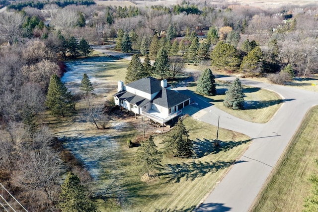 drone / aerial view featuring a wooded view