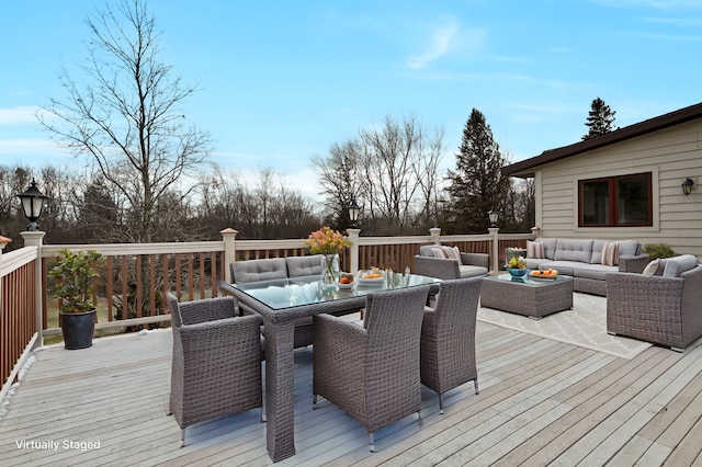 wooden terrace featuring an outdoor living space and outdoor dining area