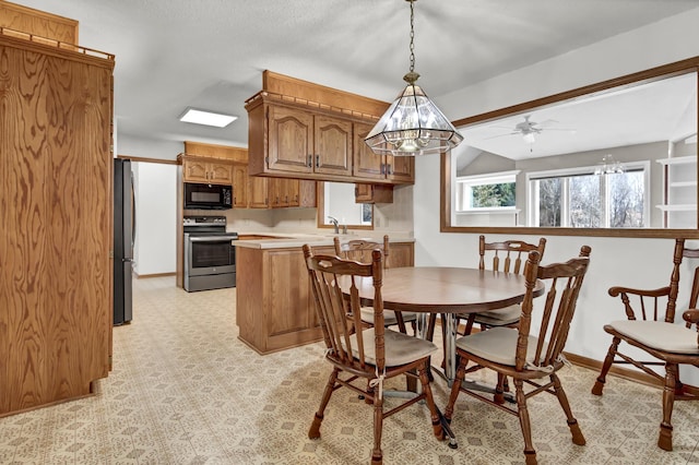 dining space featuring light floors and baseboards