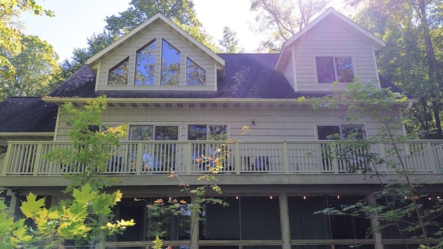 back of property featuring a shingled roof