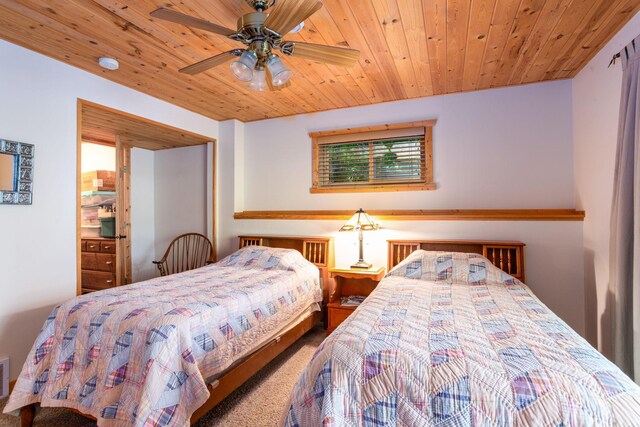 carpeted bedroom with visible vents and wooden ceiling