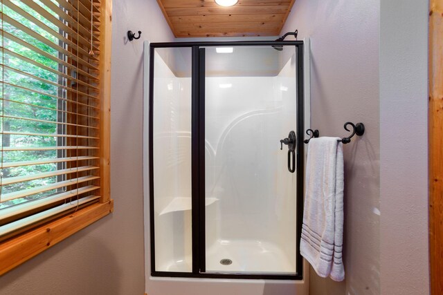 full bath featuring a shower stall and wood ceiling