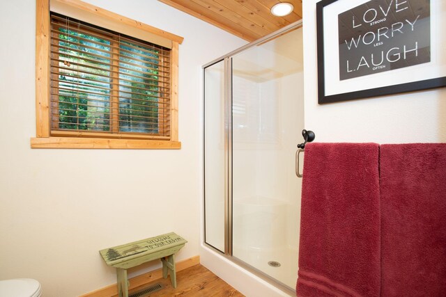 full bathroom featuring visible vents, a shower stall, wood ceiling, toilet, and wood finished floors