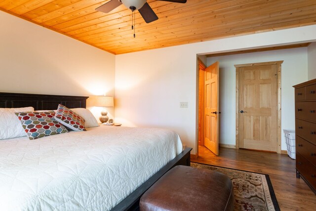 bedroom with baseboards, wood ceiling, wood finished floors, and a ceiling fan