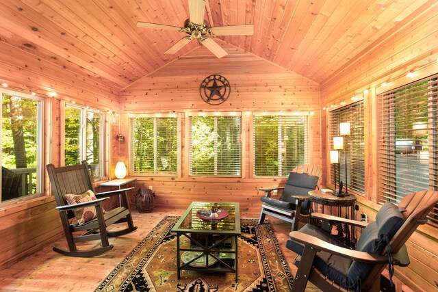 sunroom / solarium with wooden ceiling, a ceiling fan, and vaulted ceiling