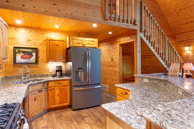 kitchen with wood walls, appliances with stainless steel finishes, and wood ceiling