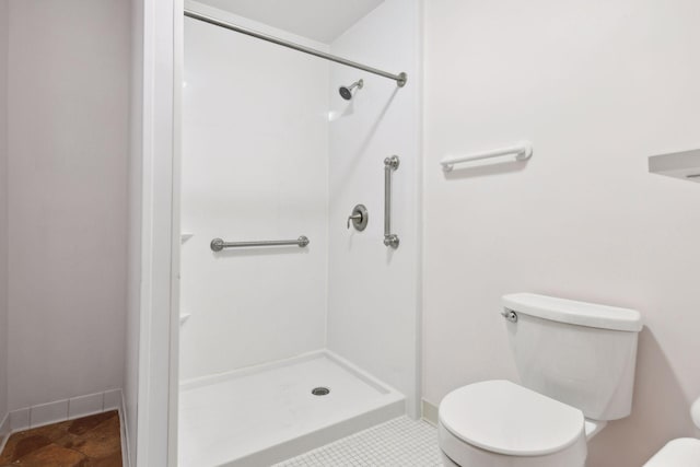 bathroom with tile patterned flooring, toilet, and walk in shower