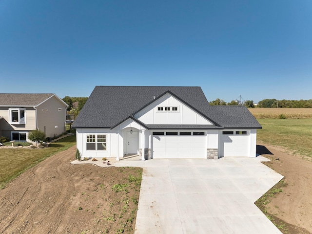 modern farmhouse style home with a garage and a front lawn