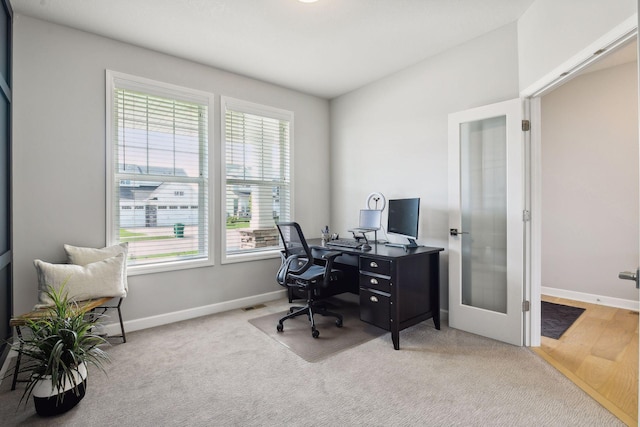 carpeted office space featuring french doors