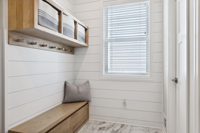 mudroom with wood walls