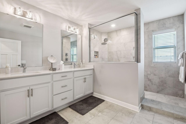 bathroom featuring vanity and tiled shower