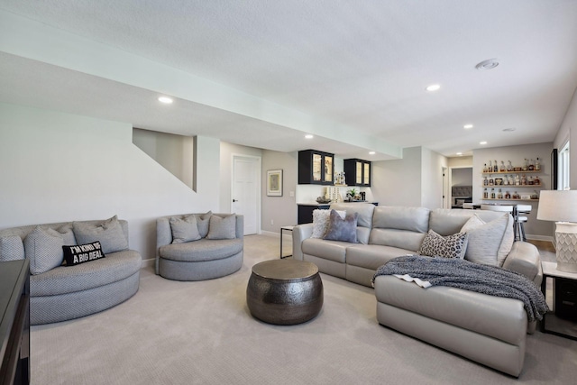 living room featuring light colored carpet and bar