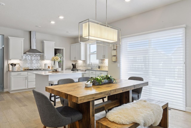 dining room with light hardwood / wood-style flooring and sink