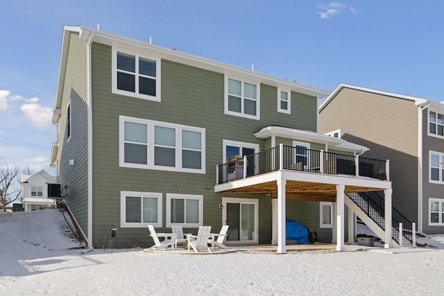 rear view of property with a deck and a patio