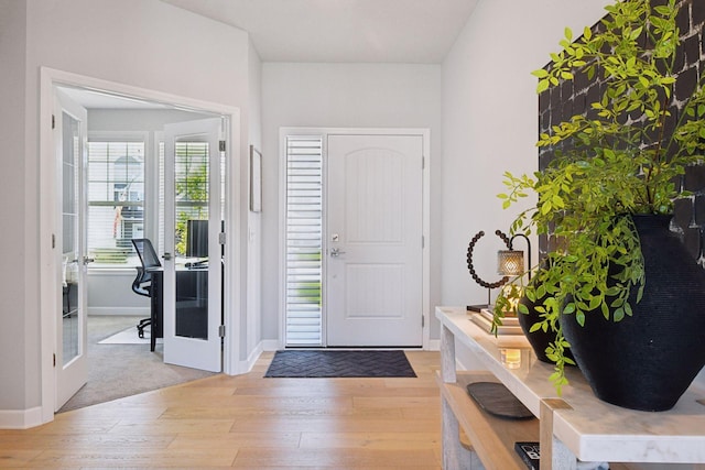 entryway featuring light wood-type flooring, baseboards, and french doors