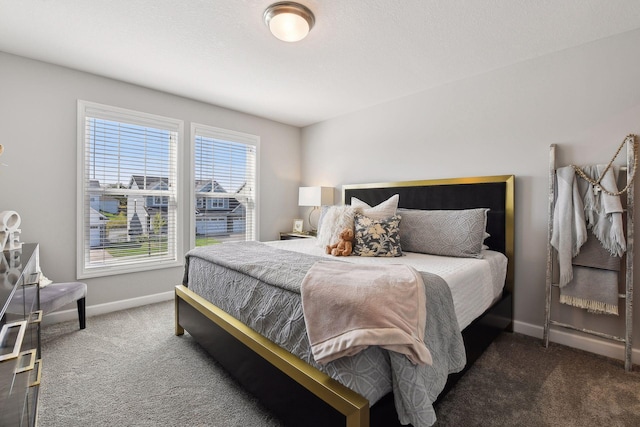 bedroom with baseboards and carpet