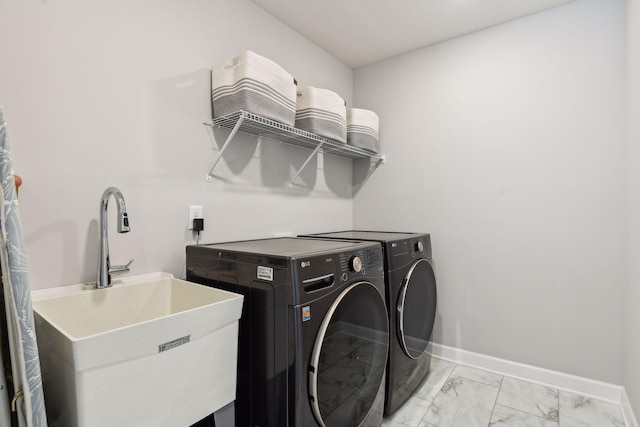 laundry room featuring laundry area, washing machine and dryer, marble finish floor, and baseboards