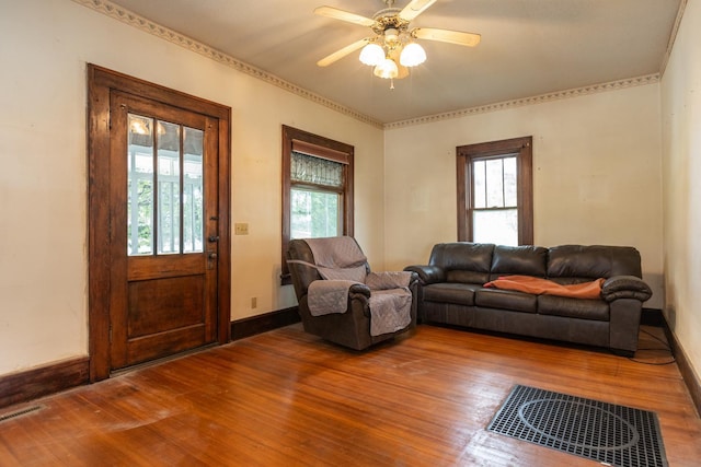 living room with wood-type flooring, ceiling fan, and plenty of natural light