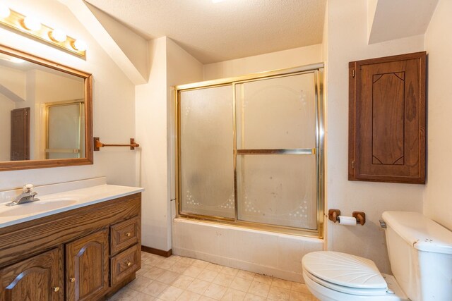 full bathroom featuring shower / bath combination with glass door, a textured ceiling, vanity, and toilet