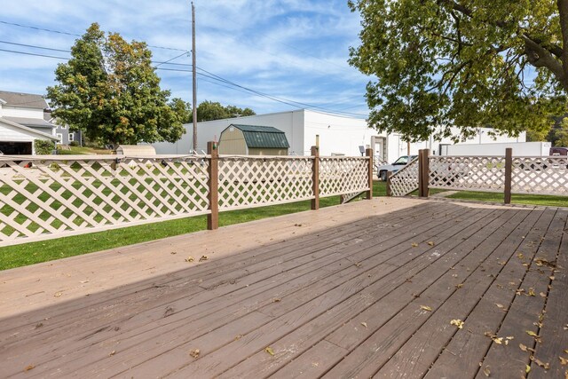 wooden terrace featuring a lawn