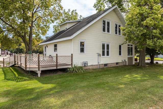 rear view of house featuring a lawn and a deck