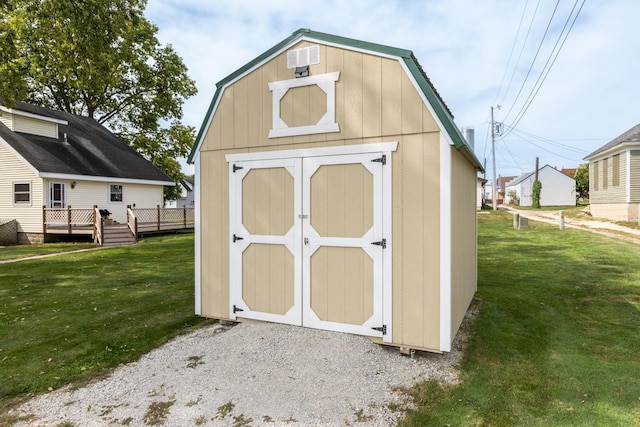 view of outbuilding featuring a yard