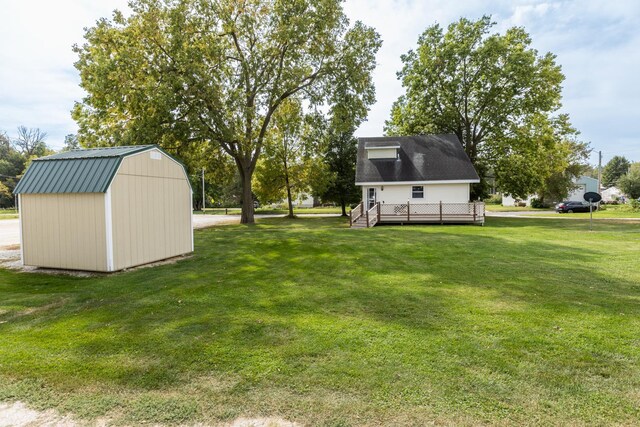 view of yard with a storage shed and a wooden deck