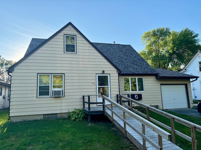 rear view of house featuring a lawn and a garage