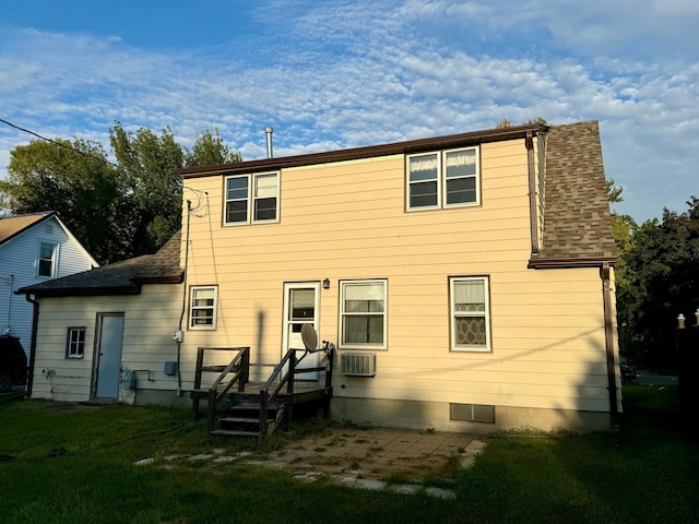 rear view of property with a lawn and cooling unit