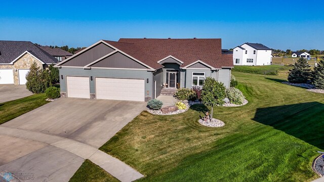 view of front facade with a garage and a front lawn