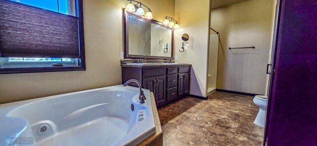 bathroom featuring vanity, toilet, a healthy amount of sunlight, and a tub