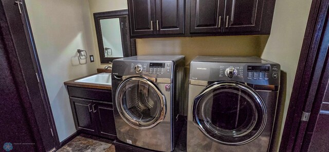 laundry room featuring cabinets, sink, and independent washer and dryer