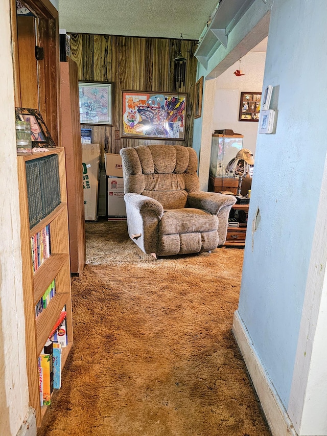 living room with carpet flooring and wood walls