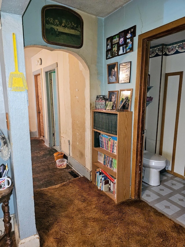 hallway with a textured ceiling